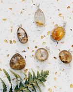 Load image into Gallery viewer, round golden rutilated quartz pendant in silver setting
