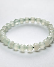 Green beaded bracelet on a white background